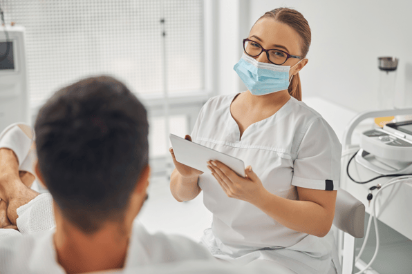 Nurse Using Incident Reporting Software in Healthcare to Improve Outcomes and Patient Satisfaction