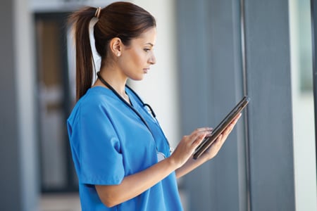 Nurse using tablet to perform risk management